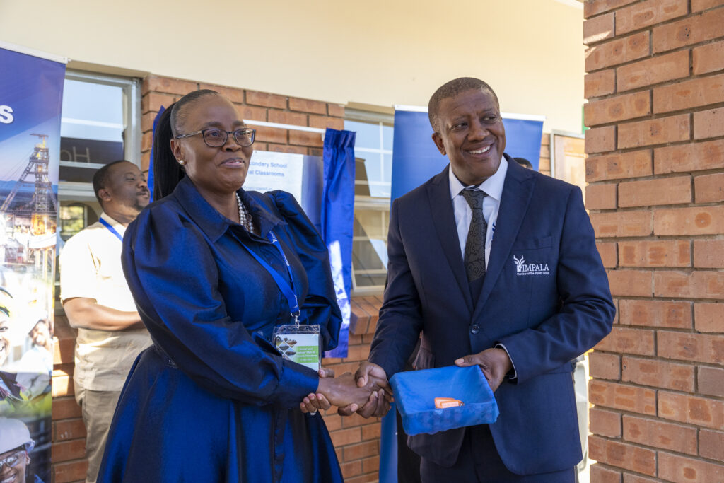 Dr MJ Paledi, Director, Bojanala District Department of Education with Moses Motlhageng, Chief Executive of Impala Rustenburg.