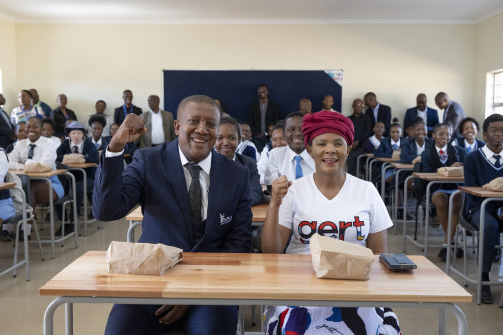Moses Motlhageng, Chief Executive of Impala Rustenburg and Cllr Shiela Mabale-Huma, Rustenburg Local Municipality Executive Mayor, with learners at Matale Secondary School.